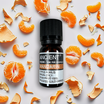 Huile essentielle de Mandarine - Aeternum - a table topped with orange and white bottles - # boutique ésoterisme# - #wicca#