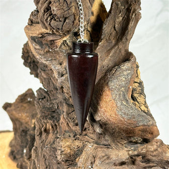 Pendule Cône en bois de rose - Aeternum - a close up of a vase on a rock  - # boutique ésoterisme# - #wicca# 