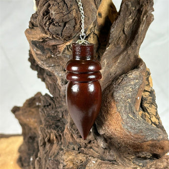 Pendule Goutte en bois de rose - Aeternum - a close up of a vase with a plant in it  - # boutique ésoterisme# - #wicca# 