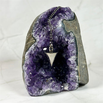 Pendule conique en métal noir - Aeternum - a close up of a chocolate covered doughnut  - # boutique ésoterisme# - #wicca# 